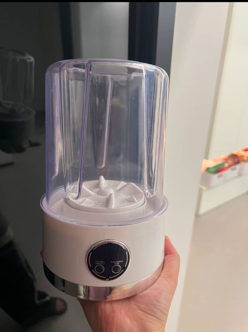 BagnShop Mini Washing Machine held in hand, showcasing its compact design and controls