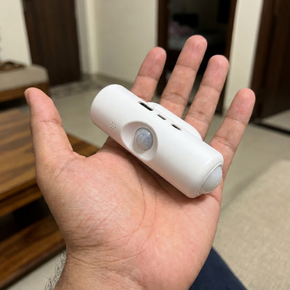 Motion Sensor Wall Light held in a hand to show its compact size